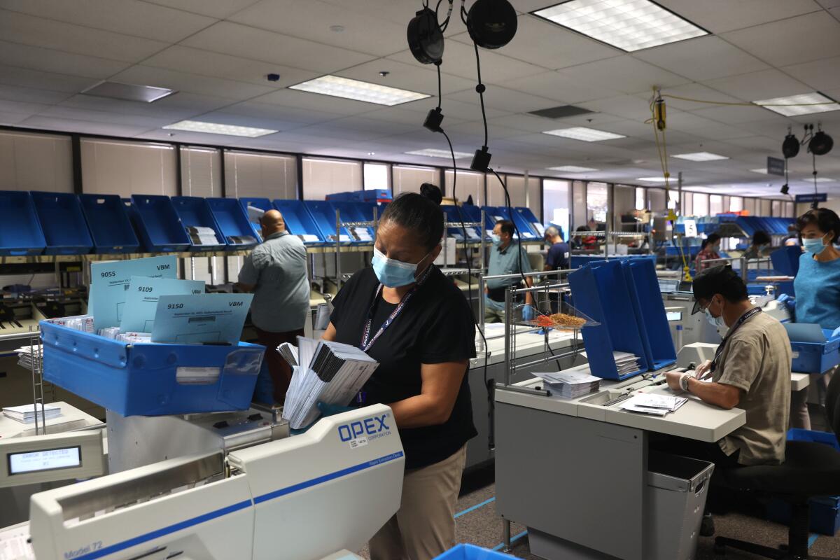 Workers sort mail-in-ballots