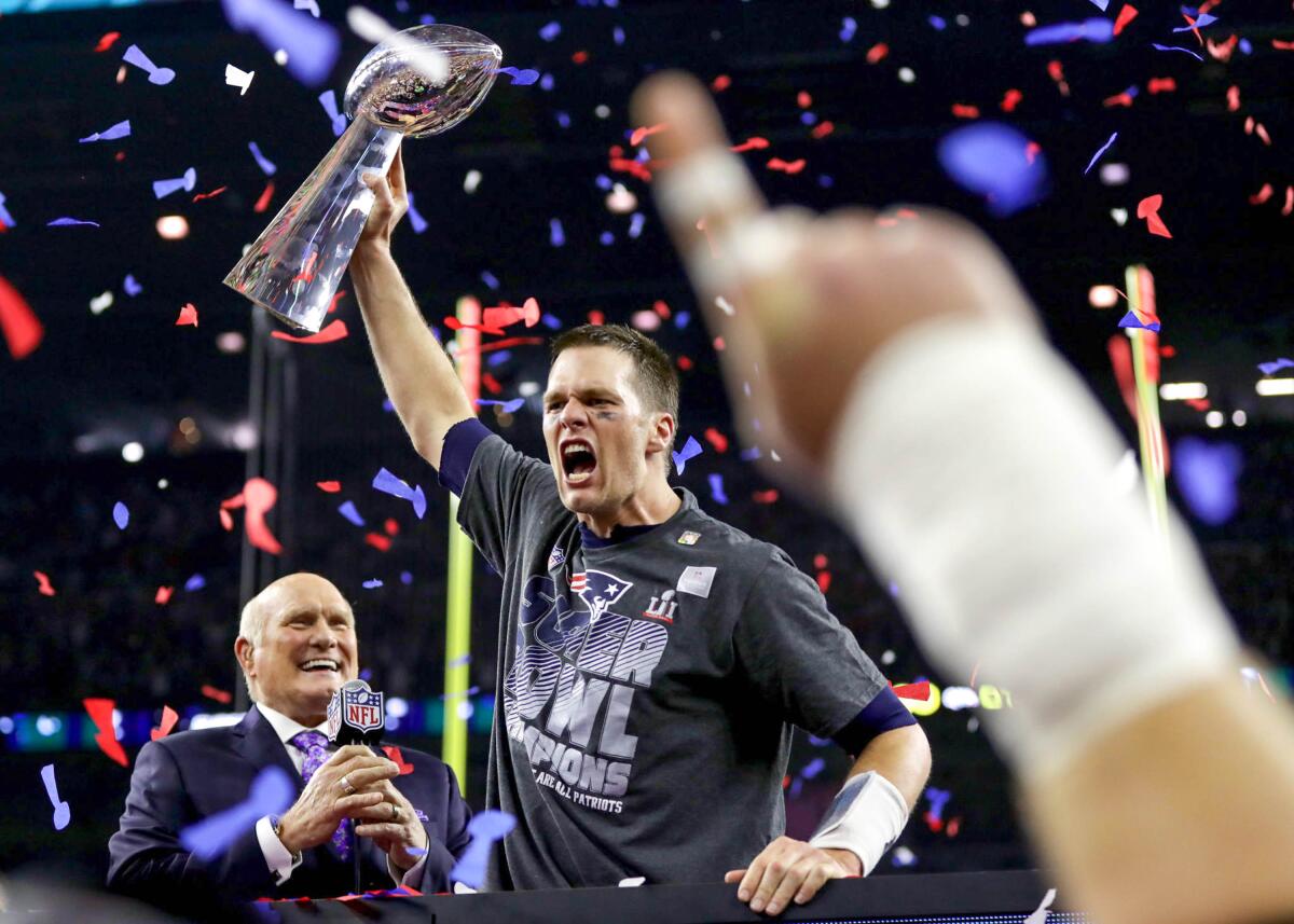 Patriots quarterback Tom Brady hoists the Vince Lombardi Trophy after winning the Super Bowl over the Falcons on Feb. 5, 2017