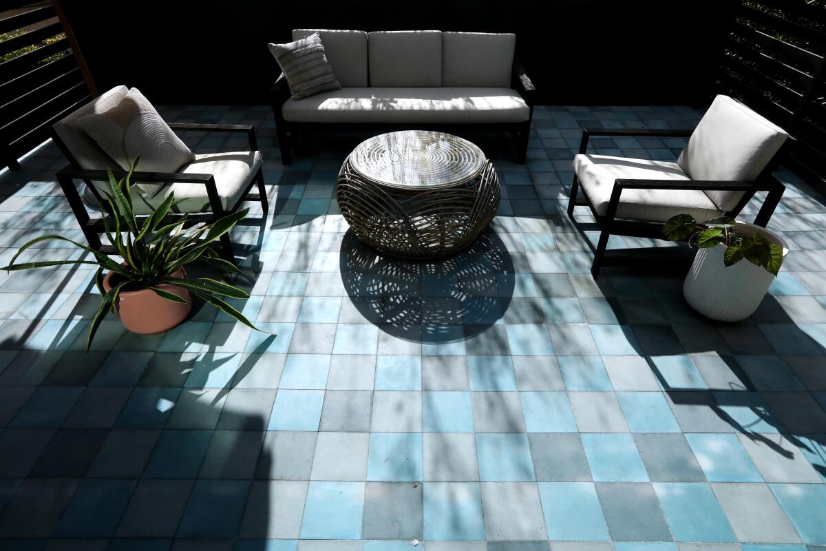 Colored concrete tile and patio furniture on the ADU's roof deck