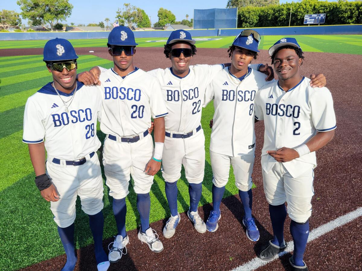 Five baseball players from St. John Bosco pose for a picture standing shoulder to shoulder.
