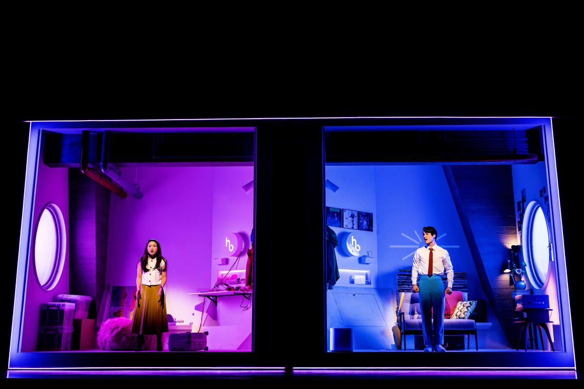 A woman stands in a furnished lavender-lighted room next to a man in a blue lighted furnished room in "Maybe Happy Ending"
