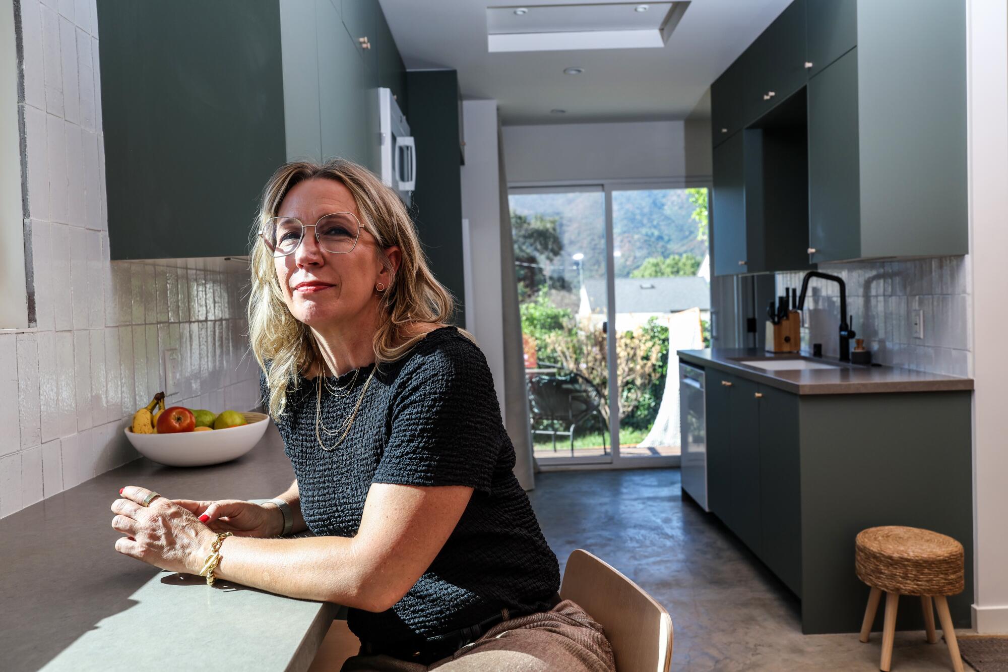 Kille Knobel sits at a bar inside her ADU.