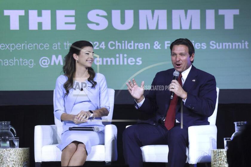 FILE - Florida first lady Casey DeSantis listens to Gov. Ron DeSantis during a panel discussion at the 2024 Florida Children and Families Summit at the JW Marriott Grand Lakes in Orlando, Fla., Sept. 4, 2024. (Joe Burbank/Orlando Sentinel via AP, File)
