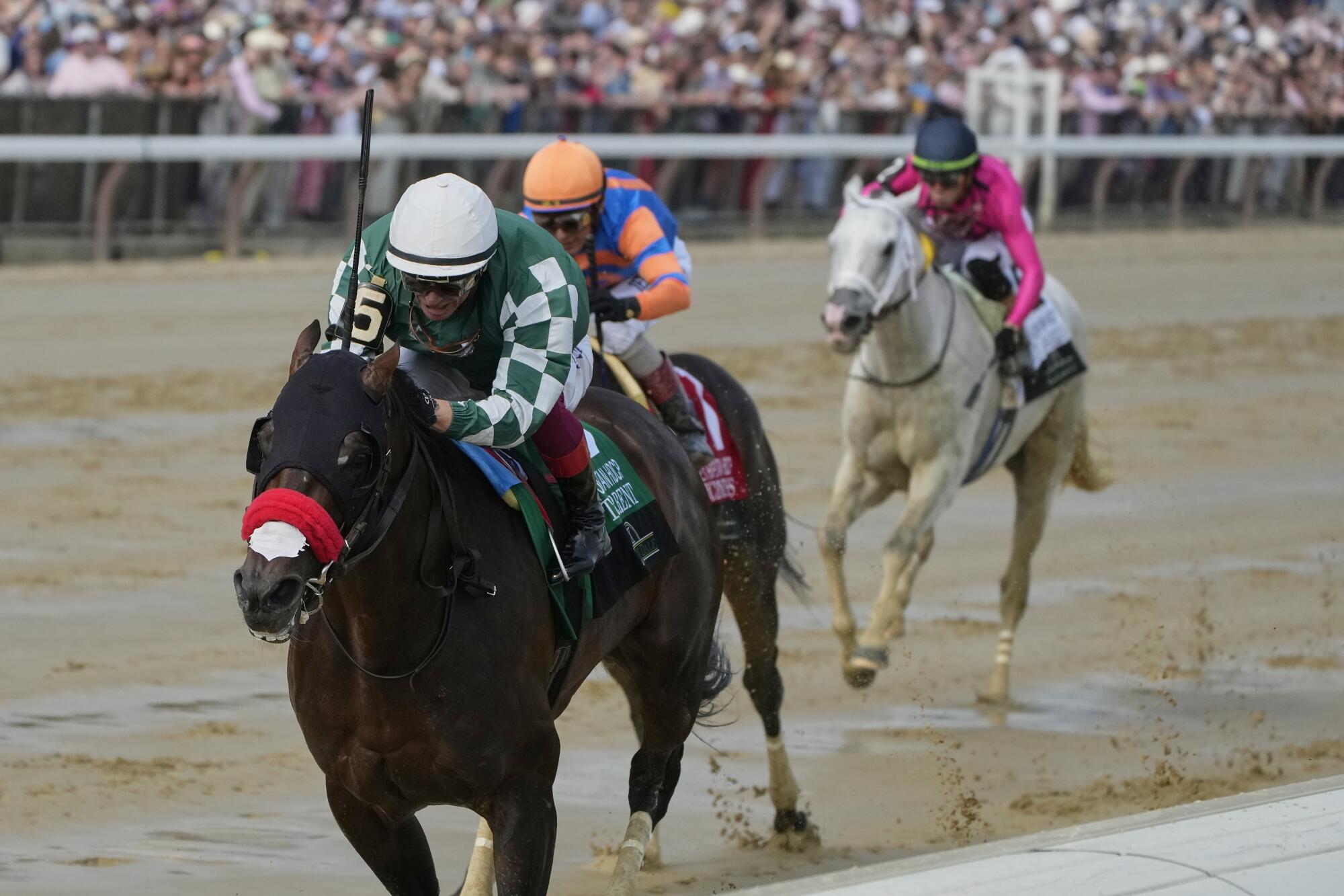 Raging Torrent, with jockey Lanfranco Dettori riding, crosses the finish line to win.