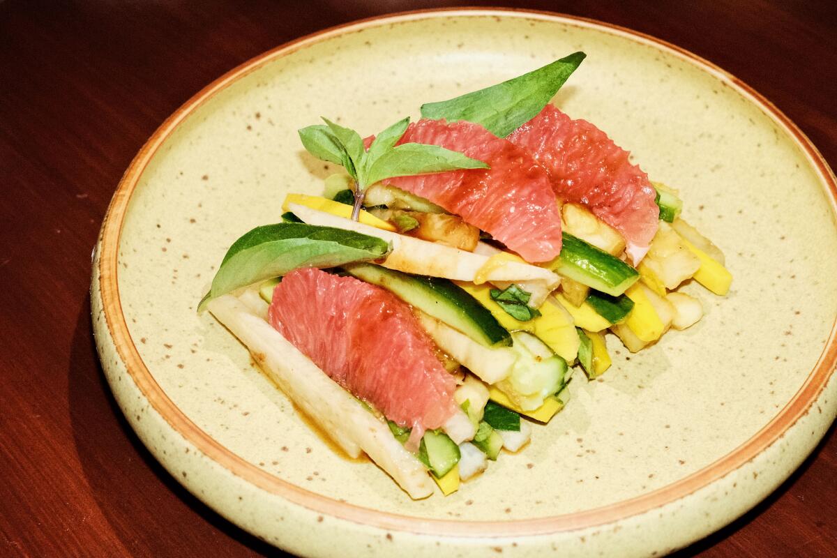 Rasarumah's small pile of thinly sliced jicama, cucumber, sour mango, tamarind and Thai basil.