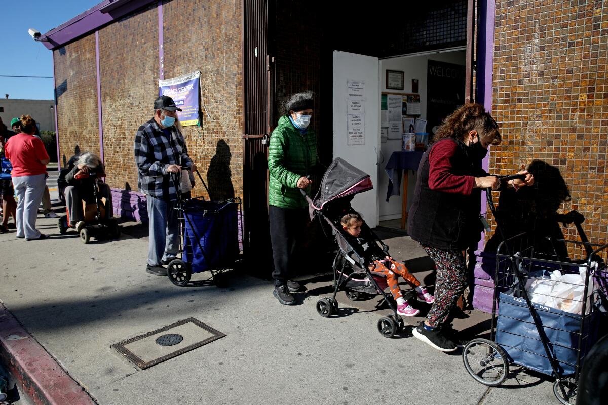 People wait in line outside a building