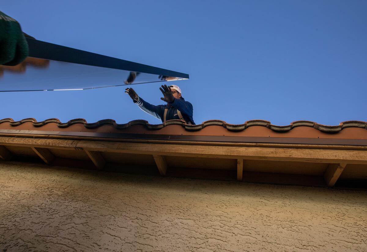 Solar panels being installed on a rooftop in North Las Vegas.