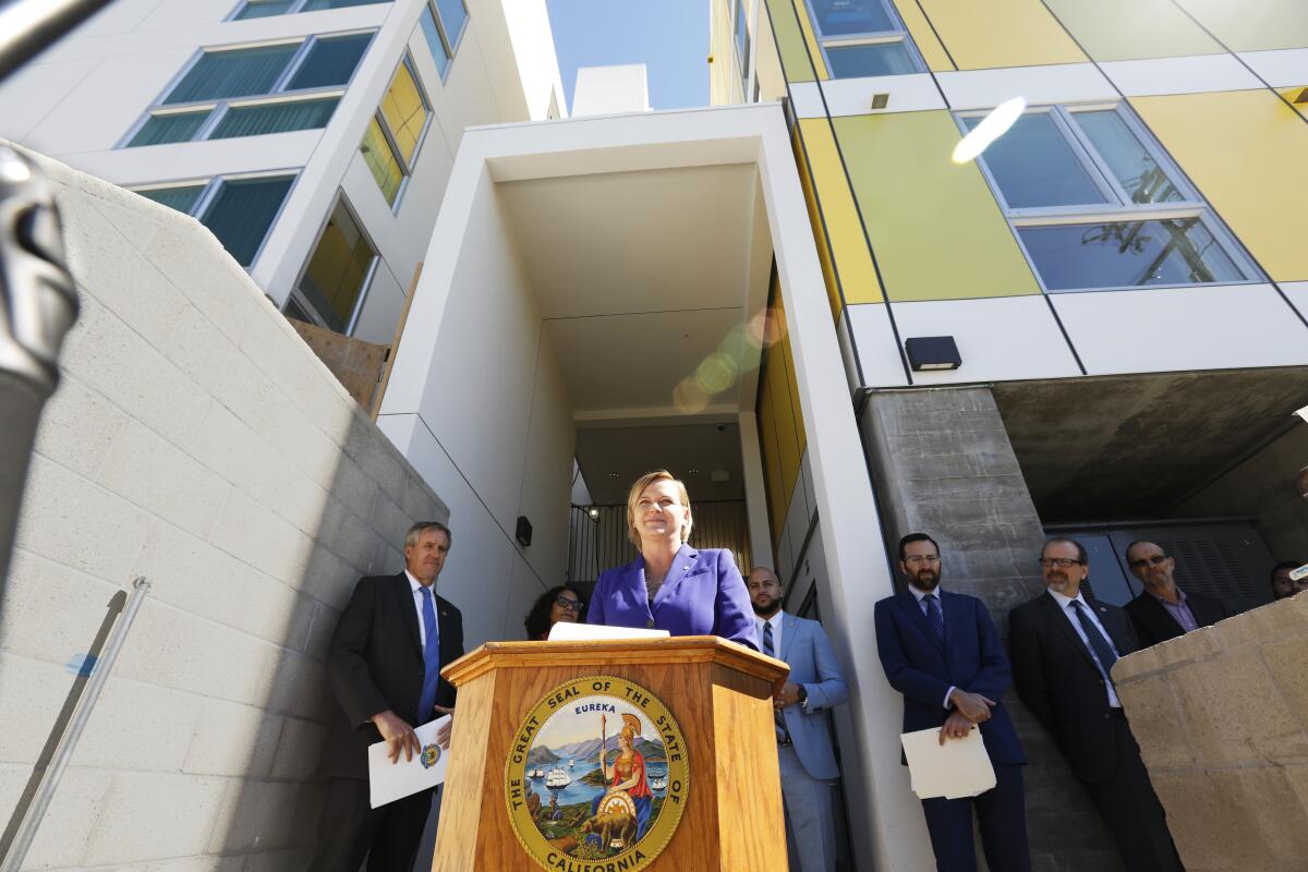 Tara Barauskas speaks before leading a tour of an all-electric apartment building in Mar Vista.