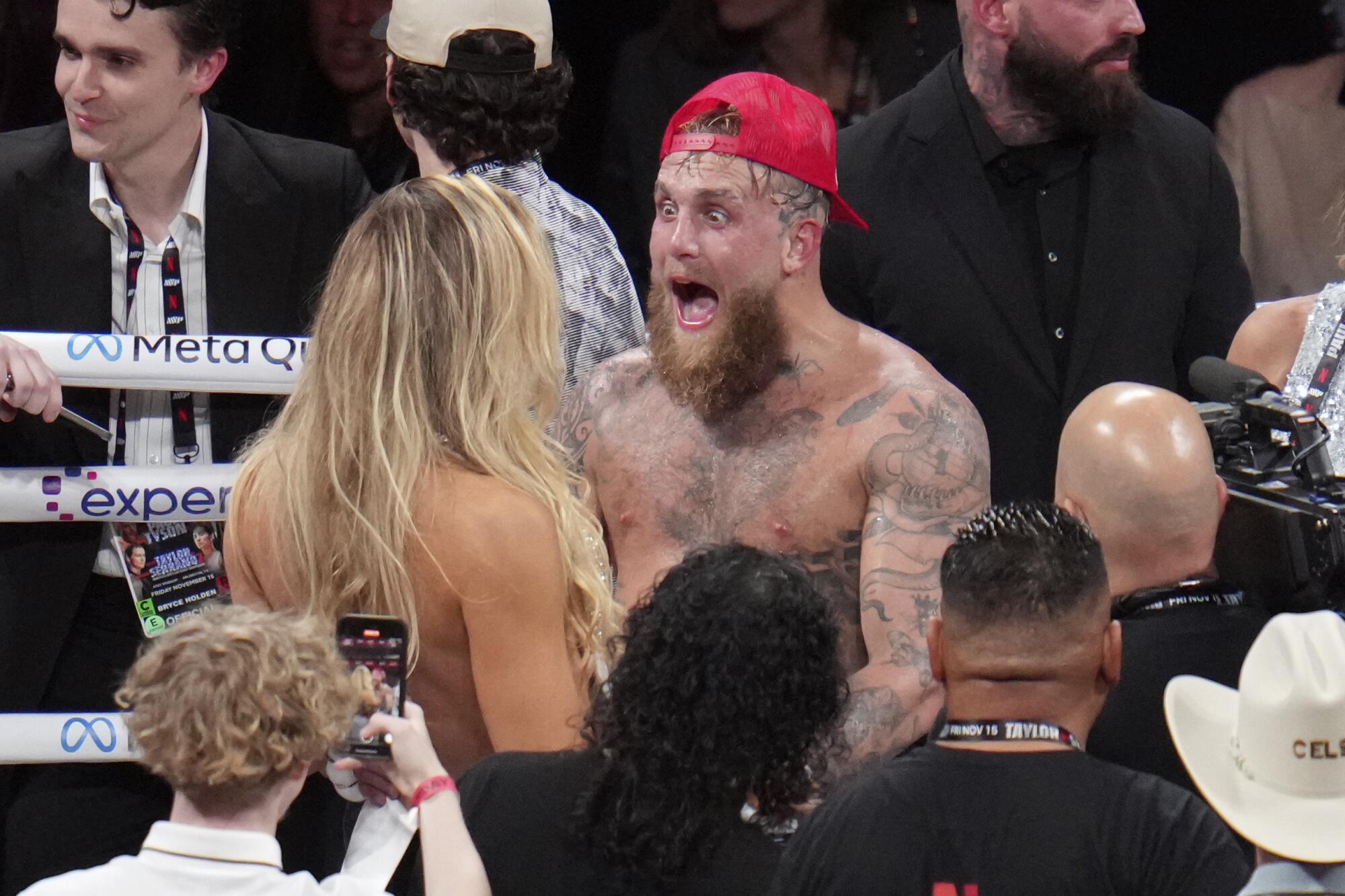 Jake Paul celebrates after defeating Mike Tyson during their heavyweight boxing match Friday.