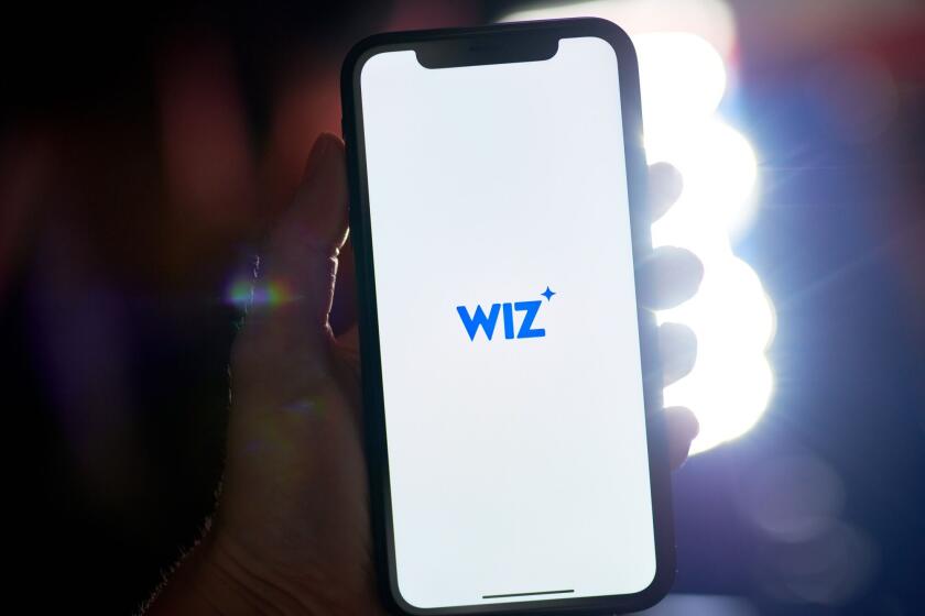 The Wiz logo on a smartphone arranged in New York, US, on Tuesday, July 16, 2024. Google parent Alphabet Inc. is in talks to acquire cybersecurity startup Wiz Inc., according to a person familiar with the matter. Photographer: Gabby Jones/Bloomberg