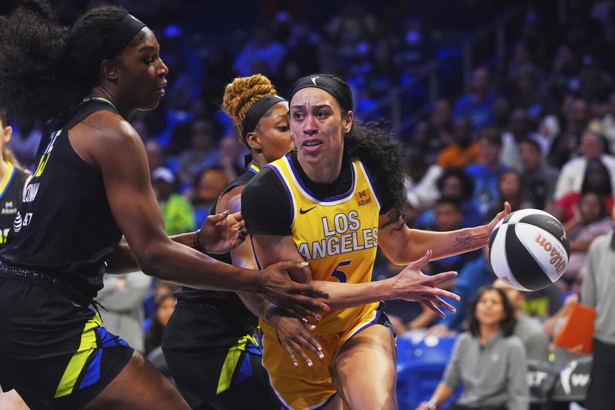 Sparks forward Dearica Hamby, right, drives against Dallas Wings center Teaira McCowan.