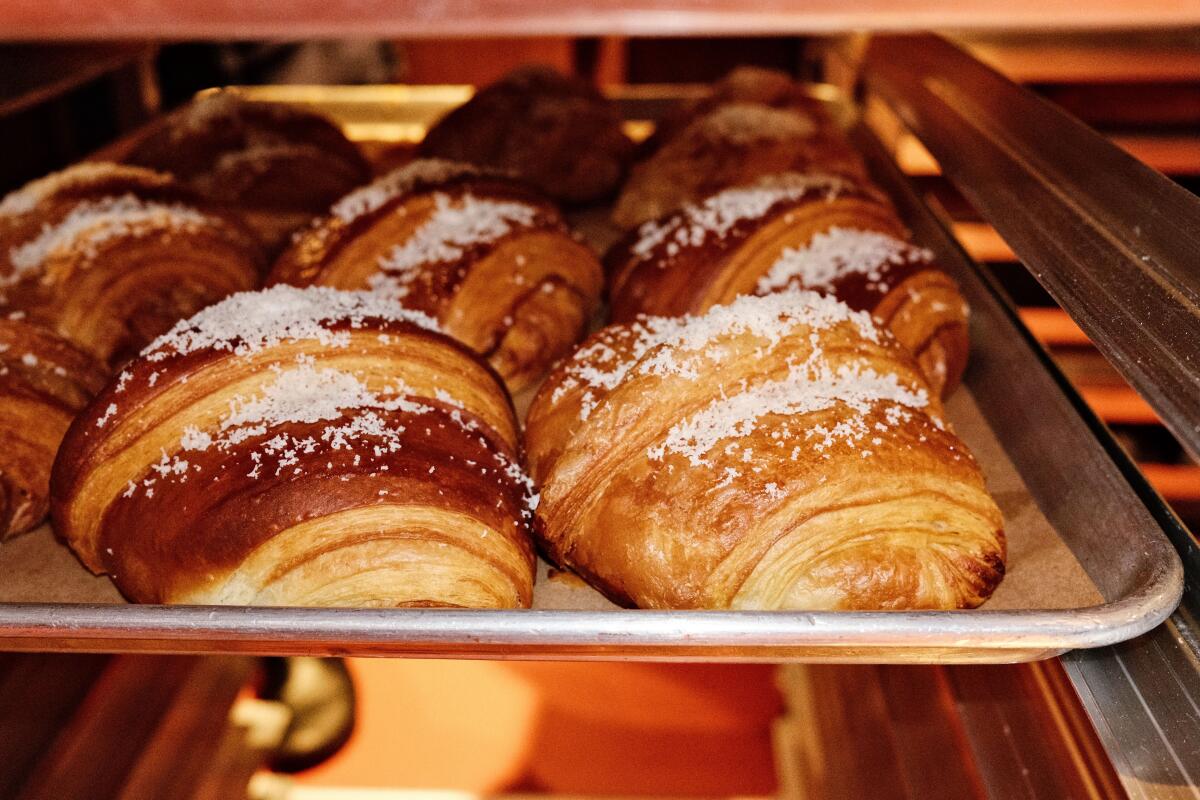 Soyrizo-and-potato croissants on baking racks at Santa Canela panadería in Highland Park.