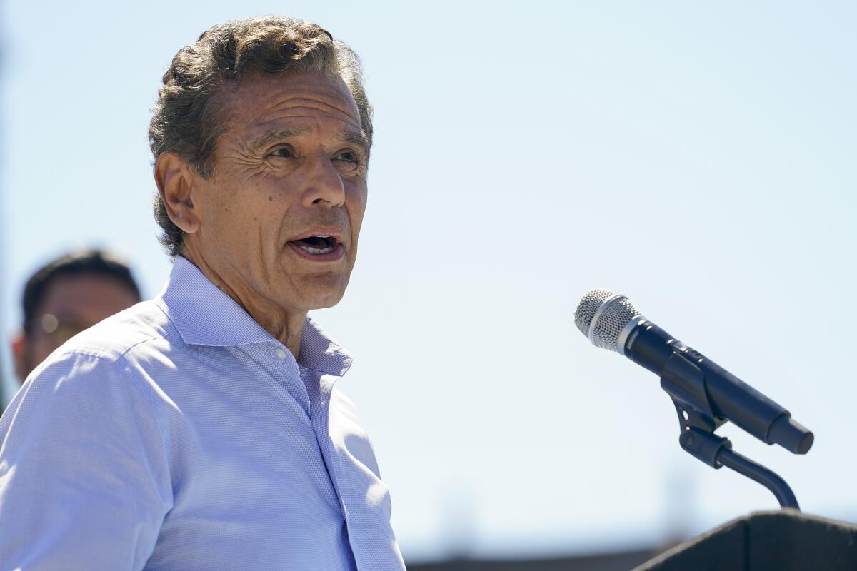 Former Los Angeles Mayor Antonio Villaraigosa speaks in front of a microphone during a news conference in Antioch, Calif.
