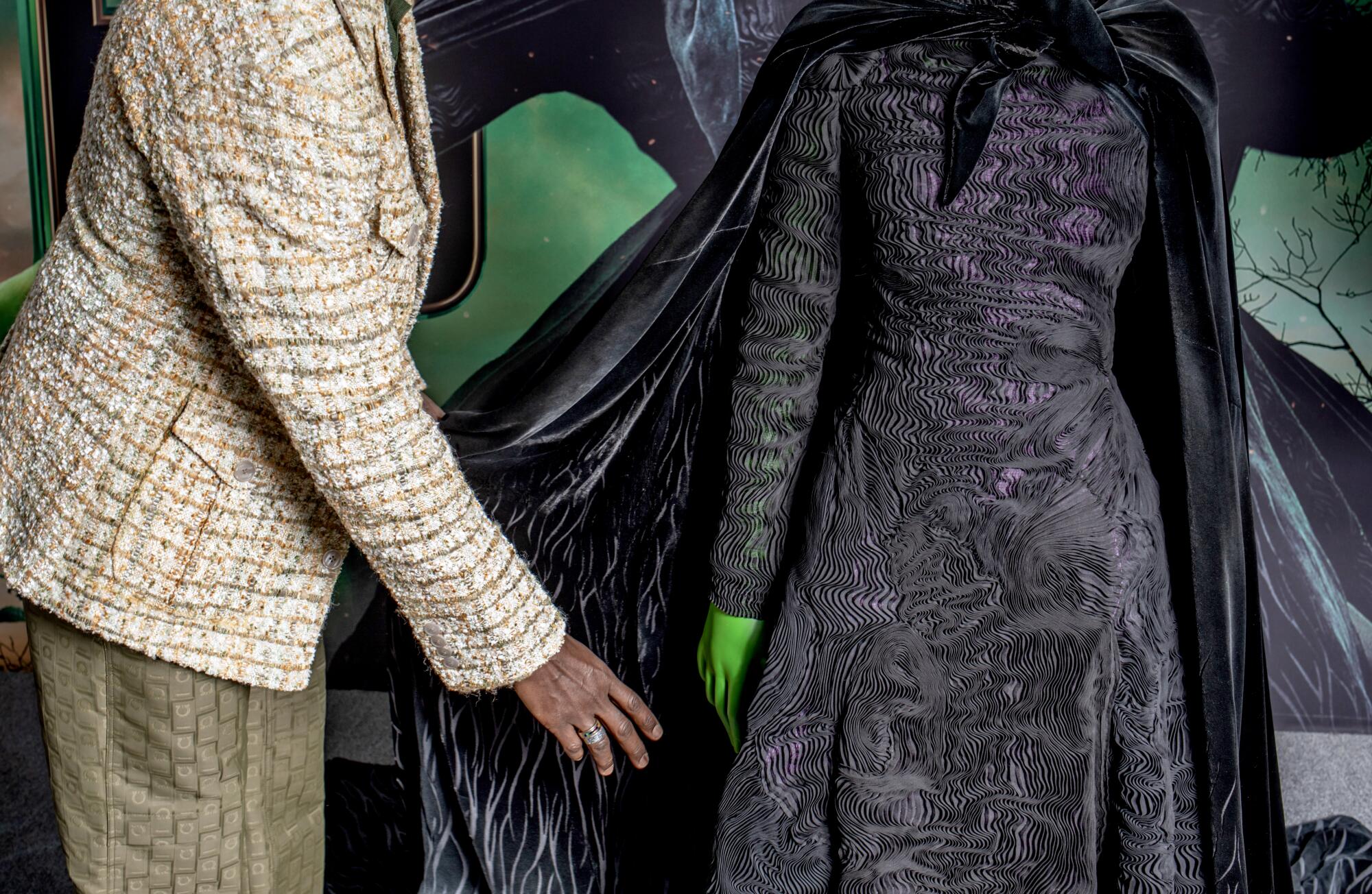 Costume designer Paul Tazewell shows off one of Elphaba's black dresses.