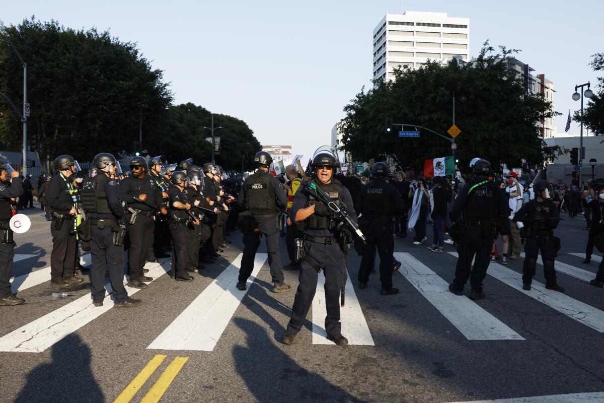 Los Angeles police officers in riot gear prepare to clear a street