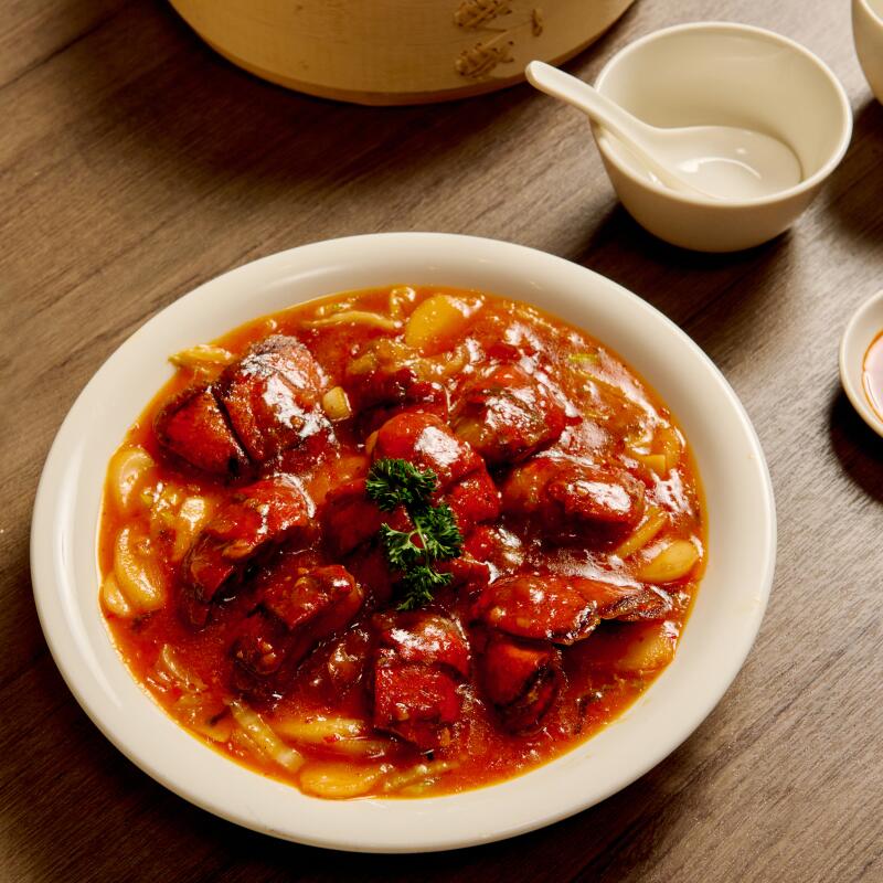 Stir-fried Rice Cake with Lobster in chili crab sauce and a steamer basket of multicolored soup dumplings
