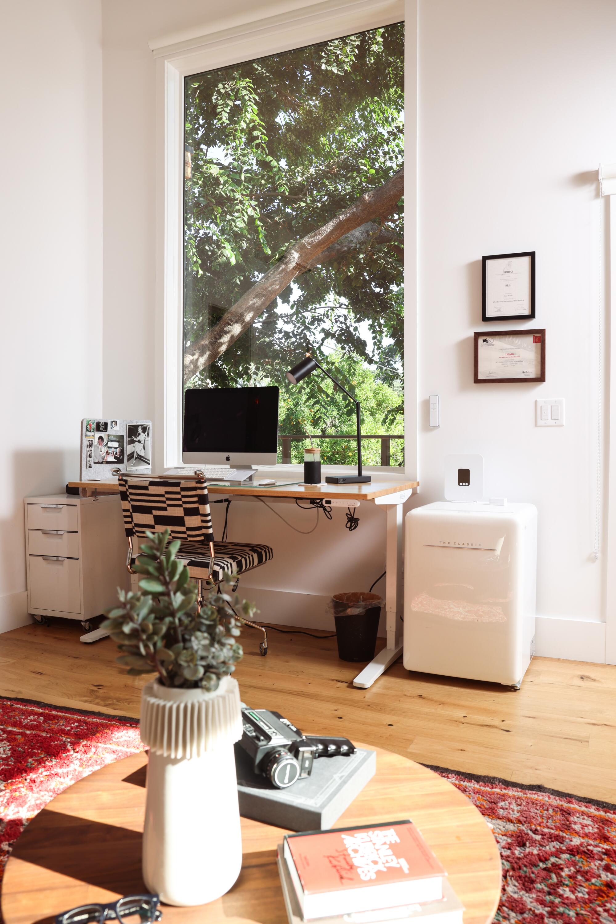 A large window above a desk in the upstairs office unit in the ADU.