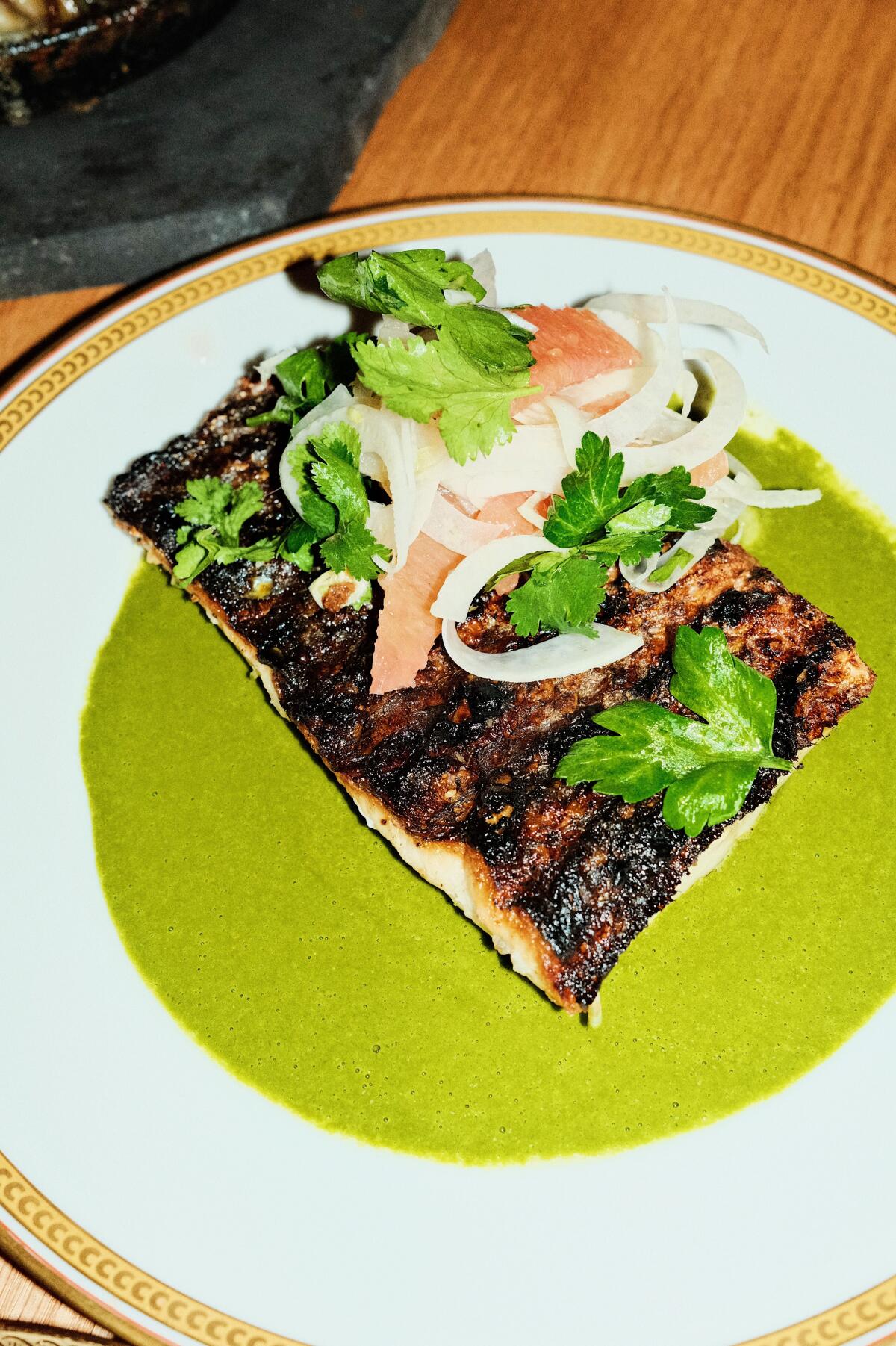 Wood-grilled striped bass with herb sauce, citrus and fennel at Bernee.