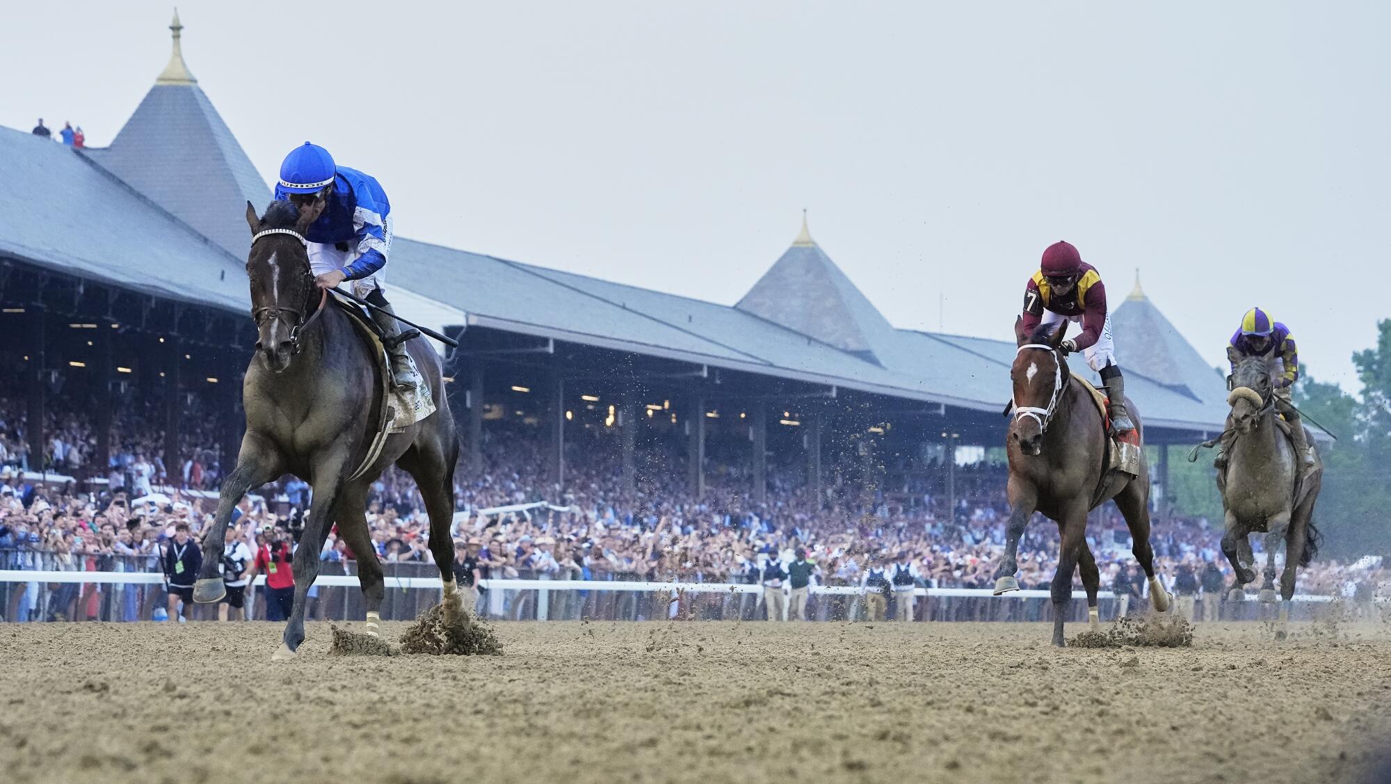 Sovereignty crosses the finish line ahead of Journalism to win the Belmont Stakes on Saturday.