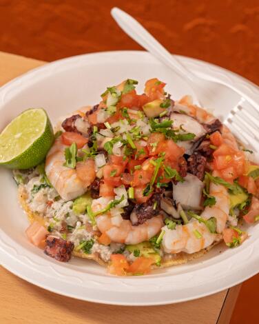 LOS ANGELES, CA - OCTOBER 24, 2024: The Tostada Mixta plate at Mariscos Jalisco in Boyle Heights. A tostada is piled high with fish ceviche, avocado, whole shrimp, octopus & veggies. (Ron De Angelis / For The Times)