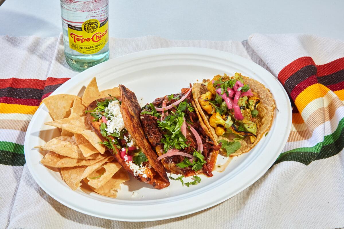 A Taco Combo plate with a Rotisserie Taco, a Birria Taco and a Charred Haldi Cauliflower Taco