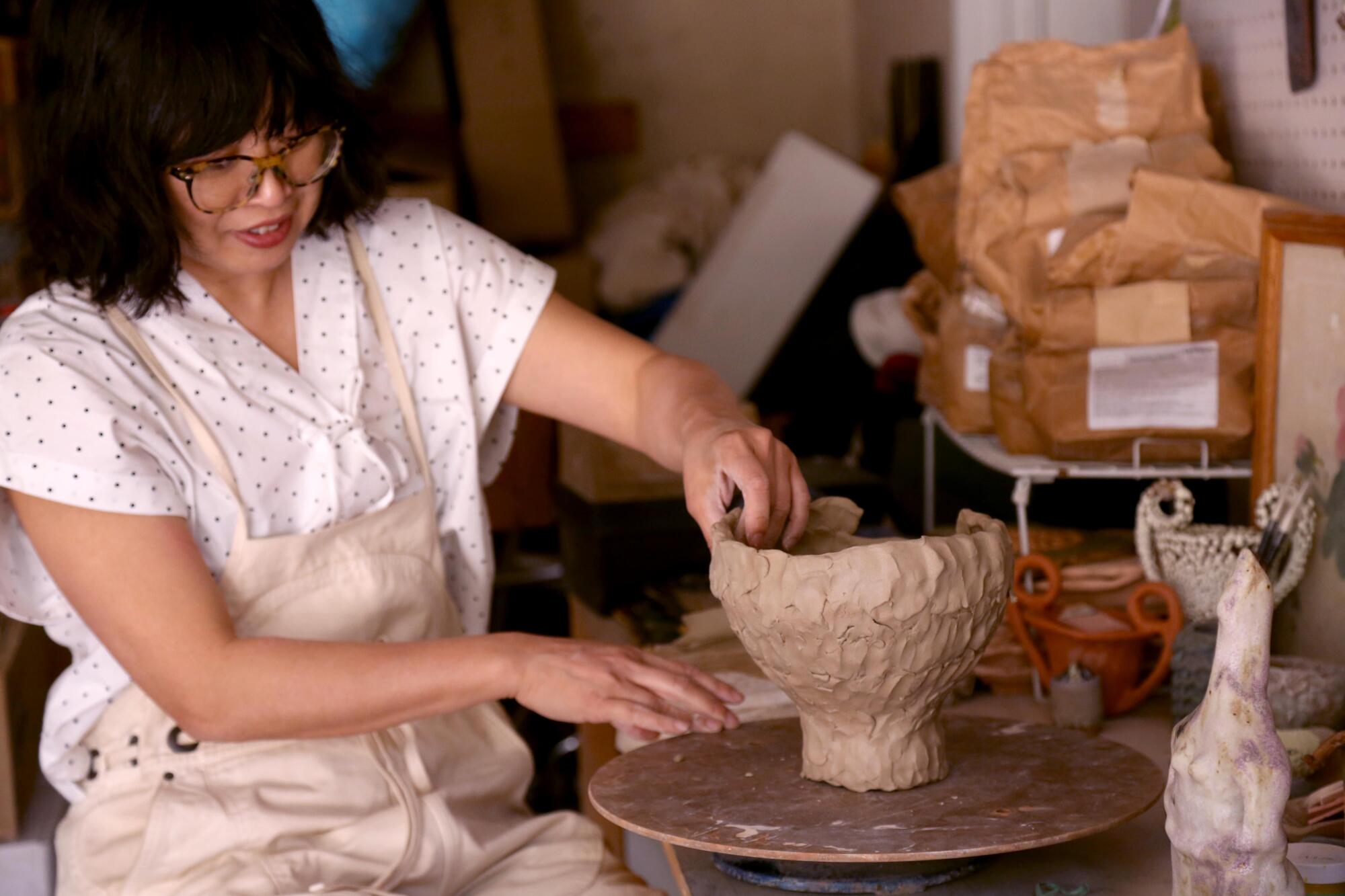 Raina Lee works on a ceramic piece in her studio garage in Mount Washington.