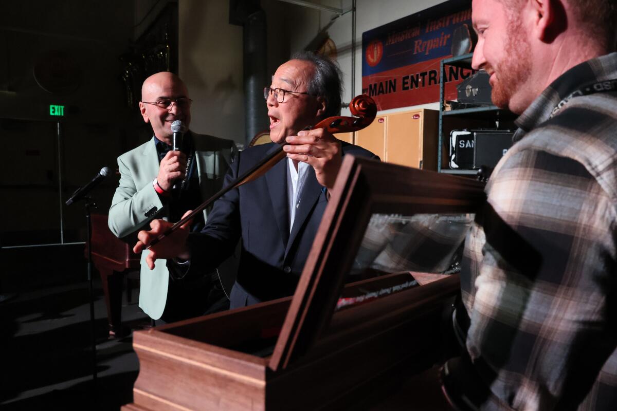 Yo-Yo Ma with Steve Bagmanyan, left, shop manager for the LAUSD's instrument repair program.
