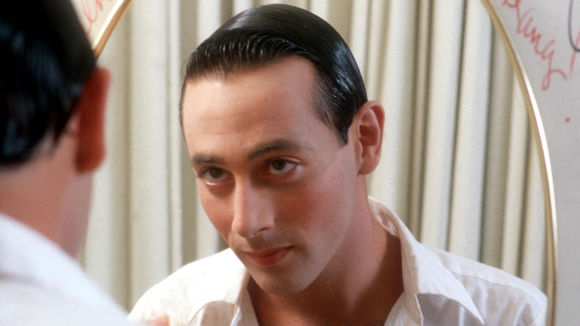 Paul Reubens as Pee-wee Herman, looking in the mirror.
