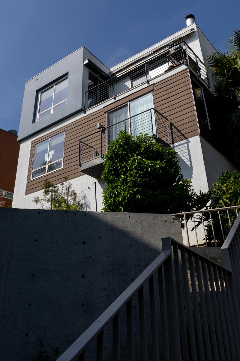 A modern two story house next to stairs
